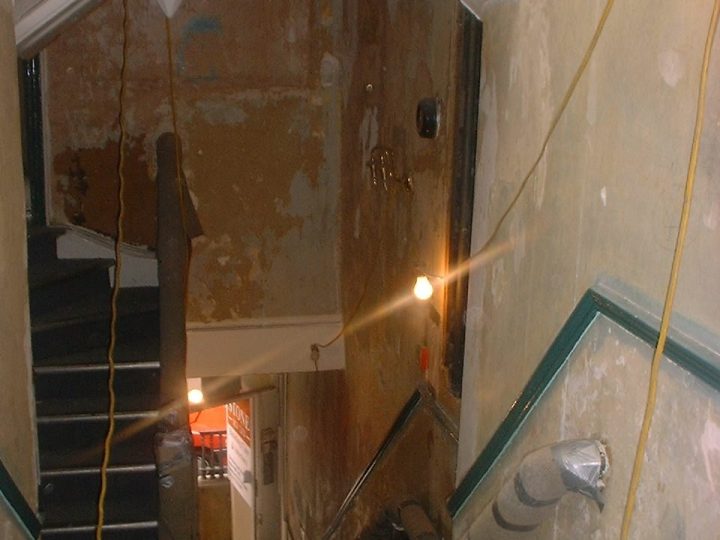 An arched doorway onto the staircase during the works