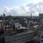 Roofscape of central Bristol showing the tower and spire of the parish church of Christ with St Ewen (left), the
