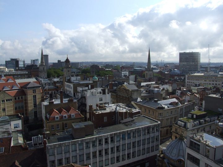Roofscape of central Bristol showing the tower and spire of the parish church of Christ with St Ewen (left), the