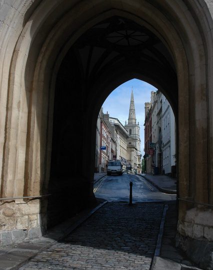 View through St John's Gate, below the tower of the Church of St John the Baptist, Bristol, looking southeast down