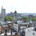 Roofscape of central Bristol showing the tower and spire of the parish church of Christ with St Ewen (left), the