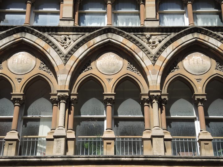 The first-floor arcade, with the words Fire, Accident, Marine, Life in its roundels